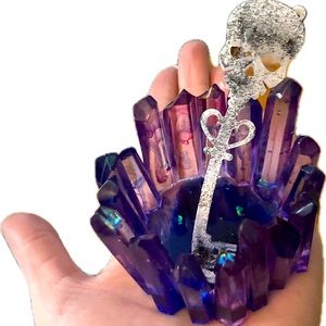 Epoxy resin crystal candle holder with a little skeleton key .